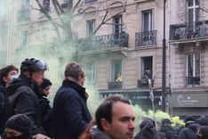 Residents look on as the demonstration slowly moves through Paris streets.