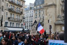 A protest sign saying "Paris, rise up".