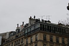 Some protesters climbed up scaffolding to reach the roof of typical Paris buildings and tag graffiti on the chimneys. 