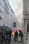 Small fires start in the path of the demonstration as protesters set rubbish bins and bus stops on fire.