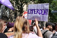 A protest sign saying: "Women screw the R-hate", a wordplay on the initials of the far-right party Rassemblement National (RN).