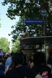 A protester sits on the roof of a bus stop.