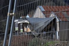 The collapsed roof of a farm building in Trooz, right next to the Vesdre river.