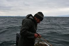 Austrian fisherman Franz Blum on his boat in the Lake of Constance. Blum comes from a family of fishermen, but today he barely earns enough money from his work as fish stocks have crashed.