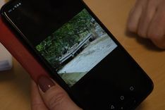 Valérie Constant scrolls through pictures she took in the aftermath of the floods.