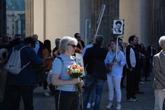 A participant of the "Victory Day" parade. Participants traditionally parade with flowers and portraits of their family members having fought in WW2.